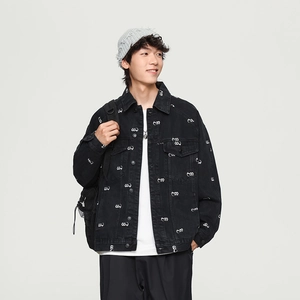 Detailed close-up of a men's black denim jacket with white all-over abstract logo print
