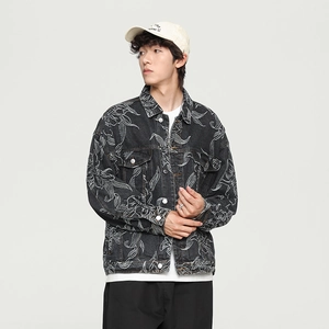 Detail of floral embroidery patterns on black denim jacket with chest pocket and lapel