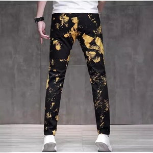Men's slim fit black denim jeans with gold splatter print streetwear style