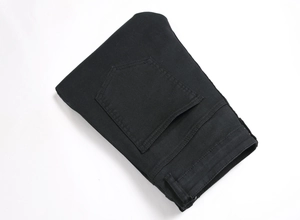 Detailed view of black denim jeans rear pocket and durable cotton twill fabric texture