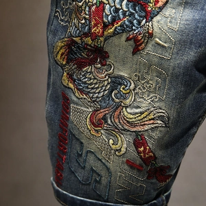 Deep blue denim shorts featuring intricate koi fish embroidery and stylish street patterns