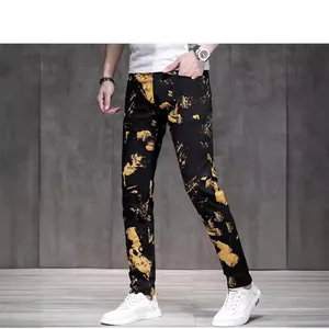 Men's slim fit black jeans with gold splash print and stretch denim fabric