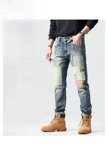 Detailed macro view of vintage blue jeans featuring stylish patchwork and distressed fading