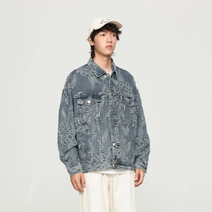 Detailed view of floral embroidery patterns on a premium dark blue men's denim jacket