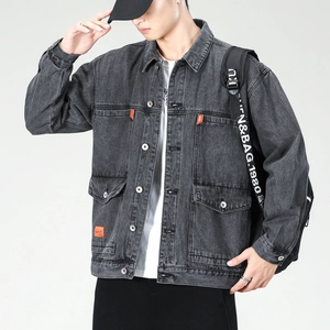 Detail of gray washed denim jacket featuring metal buttons and an orange brand tag