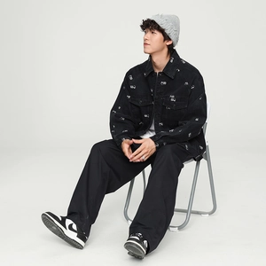 Detailed embroidery and white patterns on a black denim street style jacket for men