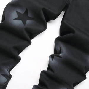 Men's black slim straight jeans featuring artistic spray-painted star patterns in street style