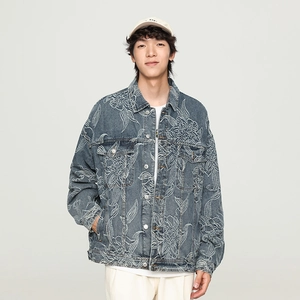 Detailed close-up of white koi and floral embroidery on a vintage blue denim jacket