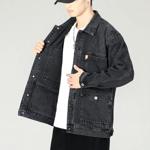 Men's loose black denim jacket with chest pockets and orange woven label detail