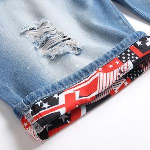 Men's light blue distressed denim shorts with American flag print folded cuffs