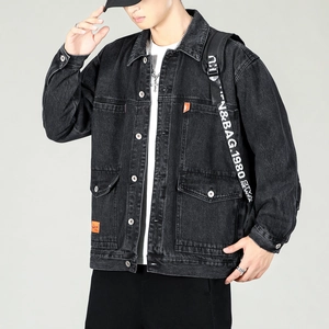 Detail of grey denim jacket with utility pockets and orange brand tag accents