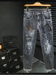 Close-up of street style washed denim with heavy embroidery and Call Me printed text