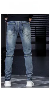 Rear view of slim fit blue men's jeans featuring 3D tailoring and wash fade effects