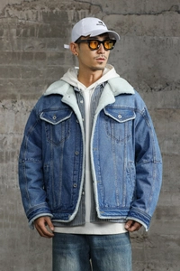 Detail of blue denim jacket with white faux shearling collar and warm fleece lining