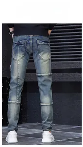 Detail showing 3D slim fit cut and back pockets of men's distressed blue denim jeans