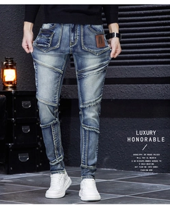 Close-up of distressed ripped denim jeans featuring frayed holes and patch details