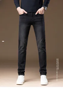 Close-up of warm fleece lining and washed texture on men's dark grey straight jeans
