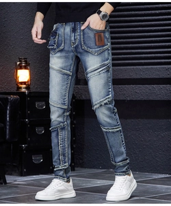 Detail of slim-fit retro blue jeans with patchwork, vintage cargo pockets and leather labels