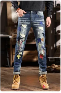 Close-up of distressed denim jeans featuring unique star patches and ripped details