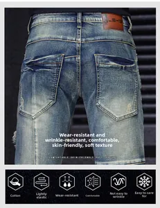 Detail of blue denim shorts showing brown leather waist patch and high-quality stitching