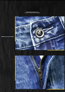 Close-up of the metal button and high-quality zipper on washed blue denim jeans