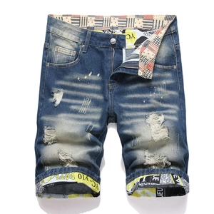 Mens vintage slim fit denim shorts with distressed ripped holes and whiskered blue finish