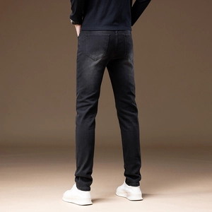Rear view of slim fit men's black denim pants with vintage washed texture and slim cut