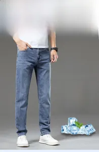 Detail of light blue stretch denim jeans showing the slim fit and oxygen-cool cotton fabric