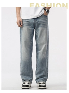 Detail view of men's loose straight jeans in light blue wash with vintage texture