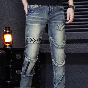Men's slim fit distressed blue denim jeans with decorative cross straps and fringe details