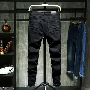 Men's slim fit black jeans with red contrast stitching and distressed rear pocket detail