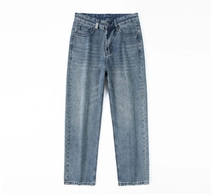 Detail of light wash blue denim jeans featuring a white vertical REPRESENT brand woven label