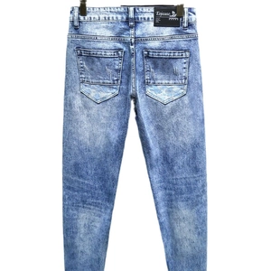 Men's slim fit light blue washed jeans featuring back pocket detail and leather waist label