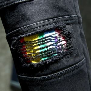 Slim fit black denim jeans for men with stylish ripped knee and rainbow striped fabric detail