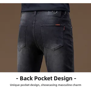 Detail view of dark grey slim jeans featuring back pocket with orange warning tag