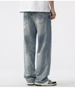 Detail of light blue vintage wash jeans showing back pockets and loose straight leg fit