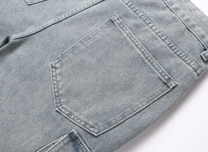 Detailed macro view of the light blue denim fabric with back pocket double stitching