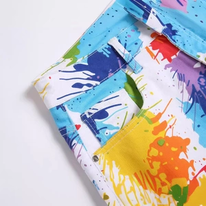Men's summer white denim shorts with vibrant colorful paint splatter and metal studs