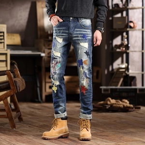 Men's slim fit distressed blue jeans with vintage patches and embroidered star details