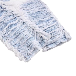 Distressed light blue denim jeans featuring heavy fringe detailing and frayed raw edges