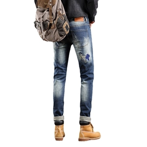 Slim fit men's distressed blue jeans with cross patch embroidery and leather waist label