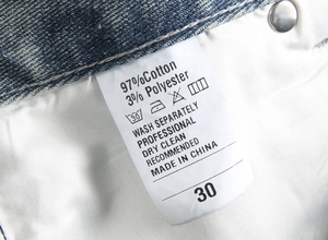 Detailed laundry label showing 97% cotton fabric composition and size 30 for men's shorts