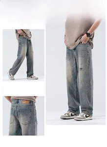 Macro detail of vintage blue washed denim jeans featuring distressed ripped holes and leather patch