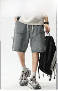 Détail macro du short en jean gris délavé avec poches cargo et taille à cordon
