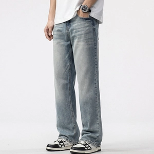 Men's loose straight leg jeans in light blue washed denim with distressed thigh fading
