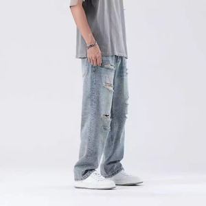 Men's light blue washed distressed jeans in a relaxed straight fit with street style details