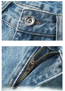 Détail d'un jean bleu clair montrant le bouton métallique et la fermeture éclair YKK