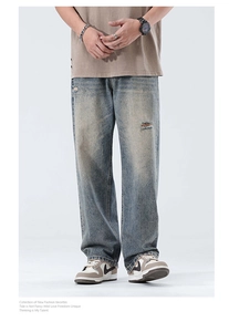 Close-up of vintage blue wide-leg jeans with distressed details and ripped knee design