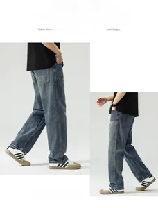 Detail view of baggy straight-leg jeans with vintage washed blue denim and side stitching