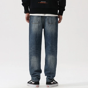 Men's vintage wash deep blue straight fit distressed denim jeans seen from the back